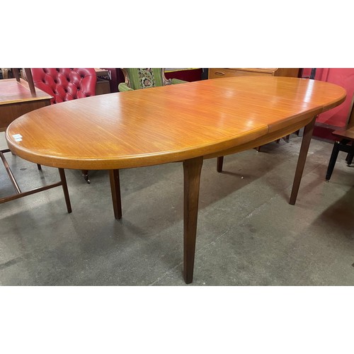 72 - A teak extending dining table