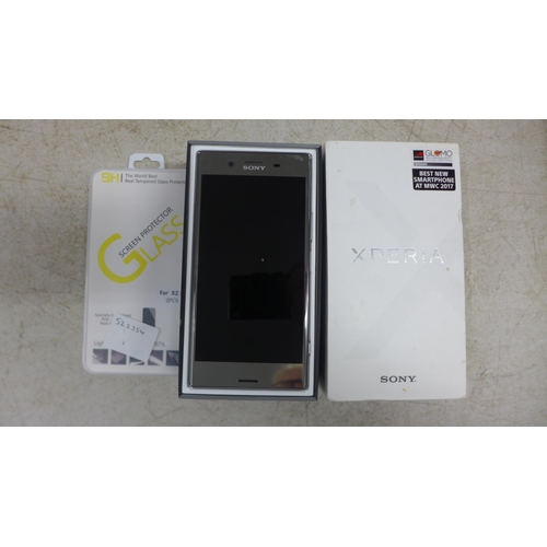 2109 - A Sony Experia X2 Premium G8141 smart phone with charging cable and replacement screen protector - i... 