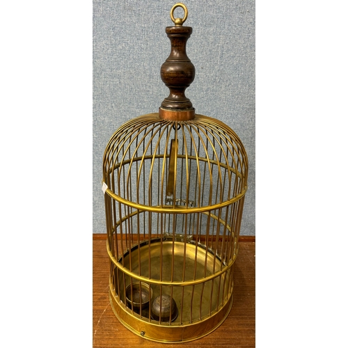 325 - An Art Nouveau brass jug, a brass coal scuttle and a brass bird cage