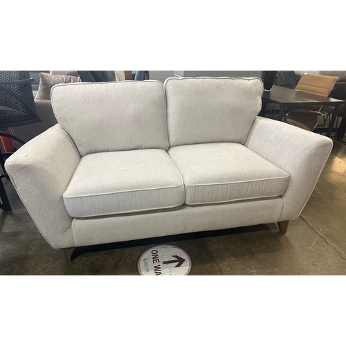 1425 - A White Fabric Two Seater Sofa