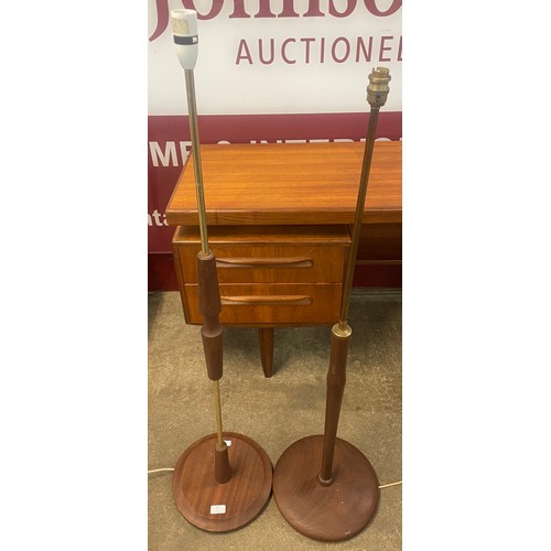 77 - Two teak and gilt metal standard lamps