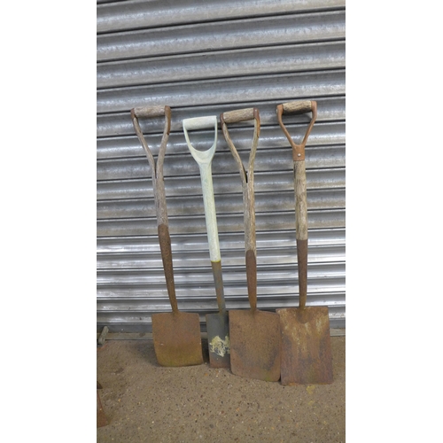 2199 - A metal wheelbarrow and a quantity of garden tools including spades, hoes, pitch forks and a rake et... 