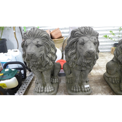 2204 - A pair of stone effect concrete lion ornaments - approximately 23