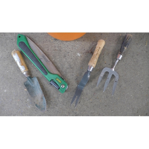 2245 - A quantity of garden tools including bow saw, rakes, brushes, a bucket, pitch fork, etc.