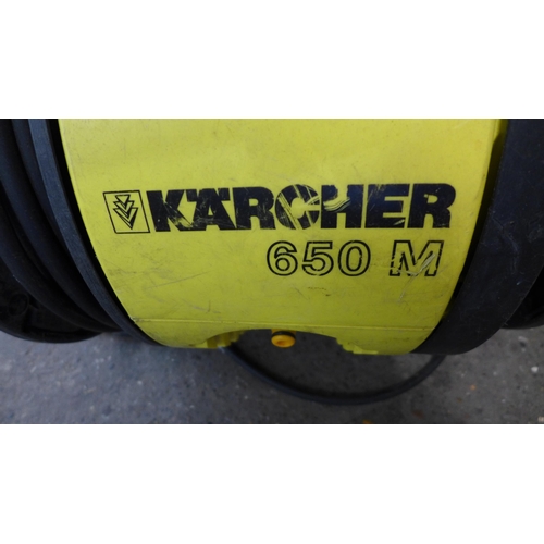 2269 - A Karcher 650M pressure washer with hose, lance and brush attachment