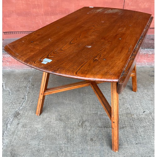 123 - An Ercol elm Windsor drop leaf table