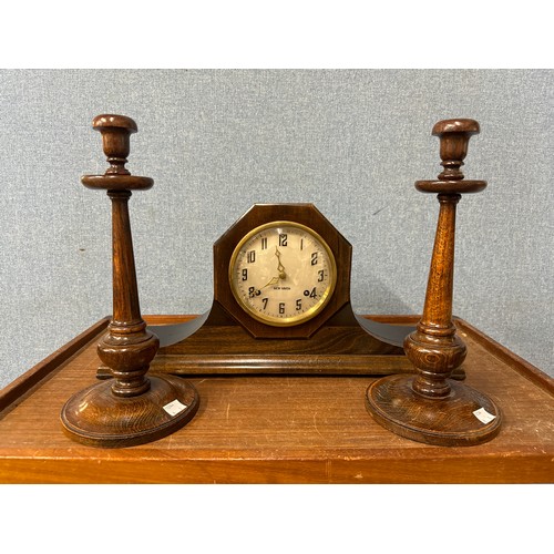 378 - A pair of oak candlesticks and a mantel clock