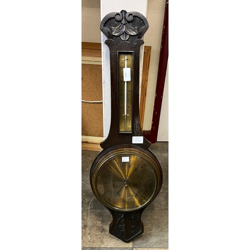 393 - A carved oak aneroid barometer