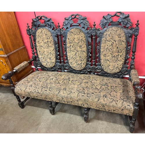 133 - A Victorian Jacobean Revival carved oak settee/sofa