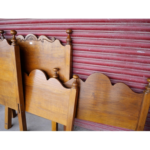 158 - A pair of Nigel Griffiths Jacobean Revival carved oak single beds beds