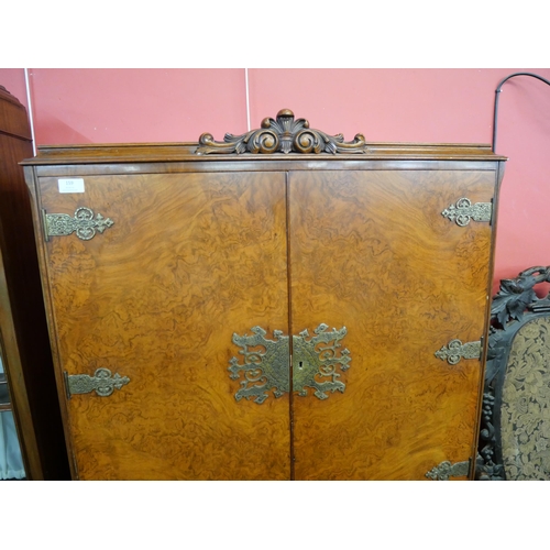 159 - A Queen Anne style figured walnut cocktail cabinet