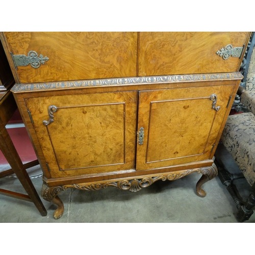 159 - A Queen Anne style figured walnut cocktail cabinet