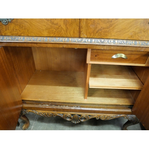 159 - A Queen Anne style figured walnut cocktail cabinet