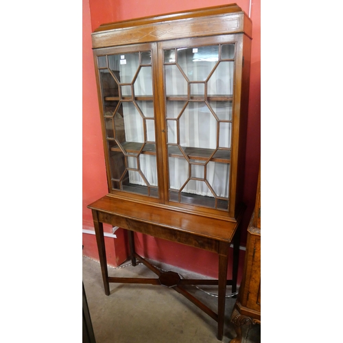 160 - An Edward VII inlaid mahogany display cabinet on stand