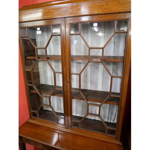 160 - An Edward VII inlaid mahogany display cabinet on stand