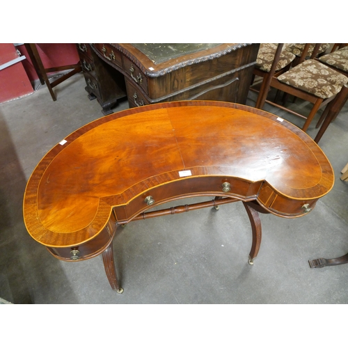 161 - A Regency style inlaid kidney shaped writing table