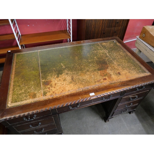 165 - A George III style mahogany and green leather topped pedestal desk