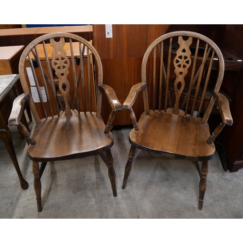 200 - A pair of beech wheelback elbow chairs