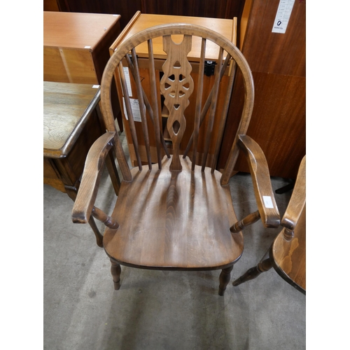 200 - A pair of beech wheelback elbow chairs