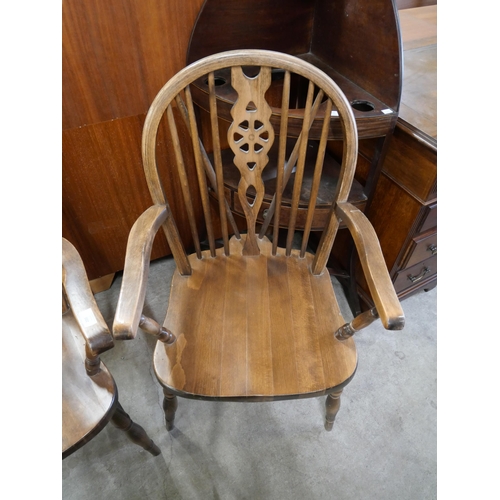 200 - A pair of beech wheelback elbow chairs