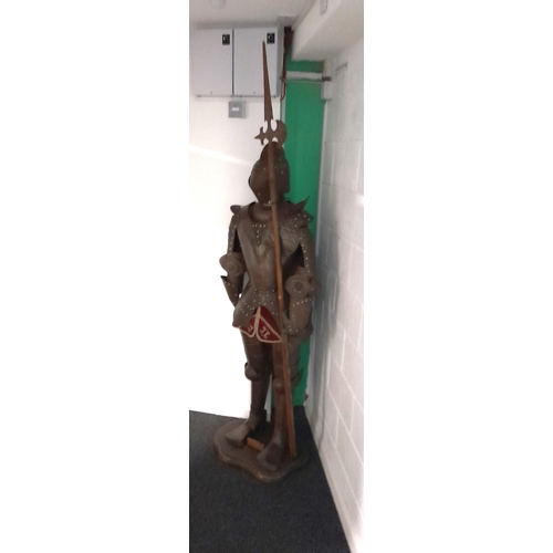 60 - A life-size display figure of a knight in a metal suit of armour. Lot is offered for sale in situ at... 