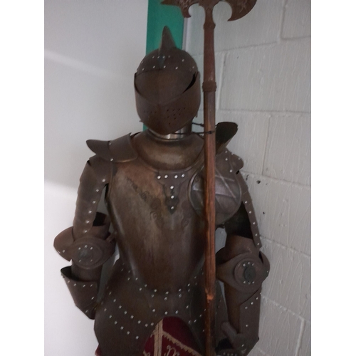 60 - A life-size display figure of a knight in a metal suit of armour. Lot is offered for sale in situ at... 