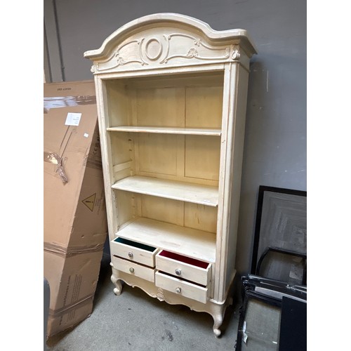 1567 - An ornate style cream painted bookcase with four drawers