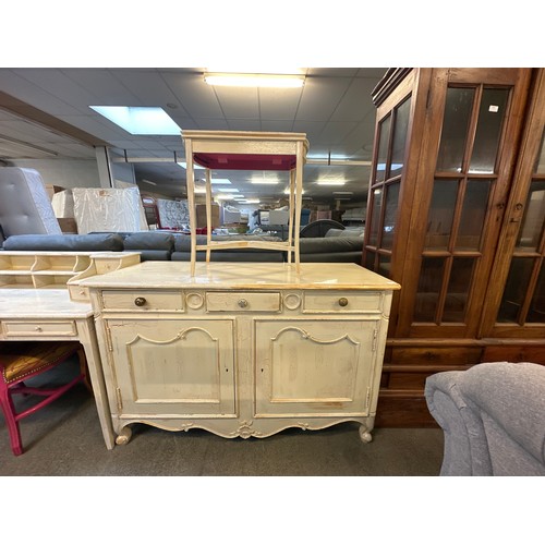 1562 - An ornate style cream painted three drawer, two door sideboard and an occasional table