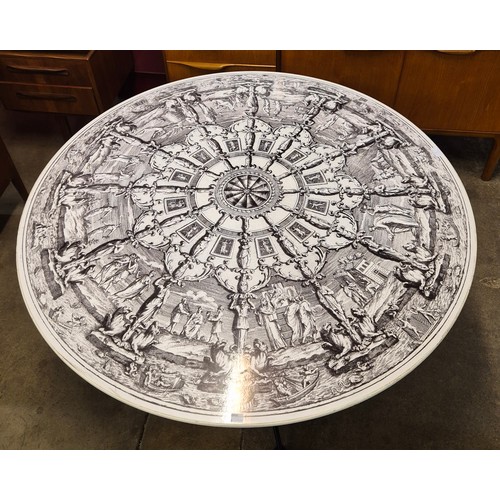 2 - A Fornasetti style circular dining table, with black and white Neo-Classical pattern laminate top, o... 