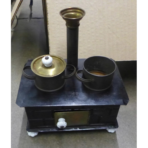 1034 - A Japanese tea set, a Victorian style child's stove toy, an eastern model of a man with a water carr... 