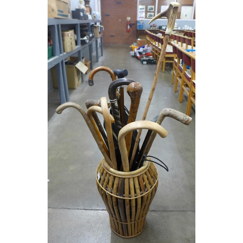 1041 - A collection of walking sticks, unbrella in a wicker stick stand **PLEASE NOTE THIS LOT IS NOT ELIGI... 