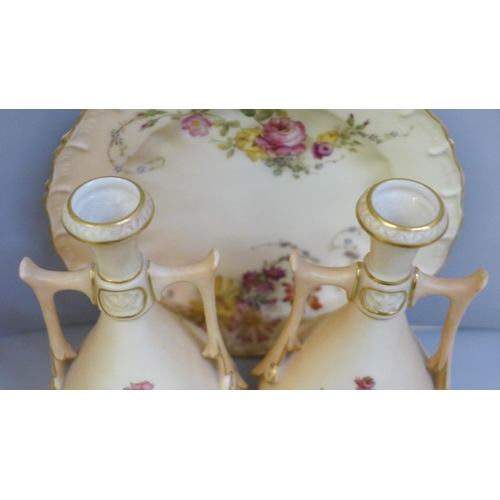 652 - A pair of Royal Worcester blush ivory twin handled vases and tea plate, decorated with sprays of flo... 