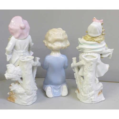 656 - A pair of Continental porcelain figural spill holders and a figure of a praying child