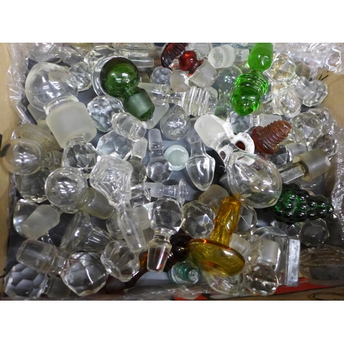 688 - A box of clear and coloured glass stoppers, perfume/scent, etc.