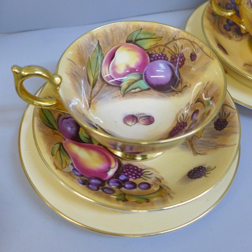 695 - Aynsley Orchard Gold cups, saucers, tea plates, a bread and butter plate and a cabinet plate, signed... 