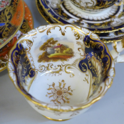 696 - A collection of Derby and Royal Crown Derby Queen's Imari cabinet cups and saucers; two with tea pla... 