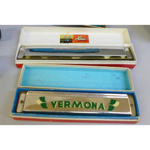 697 - A box of mixed harmonicas including a large Weltmeister plus an Orbit 8-25x30mm scope and tripod