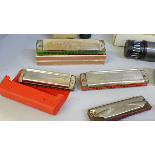 697 - A box of mixed harmonicas including a large Weltmeister plus an Orbit 8-25x30mm scope and tripod