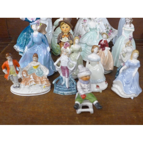 698 - A collection of seventeen porcelain figures; a Royal Doulton Shirley, Wade, Goebel, Coalport Carla, ... 