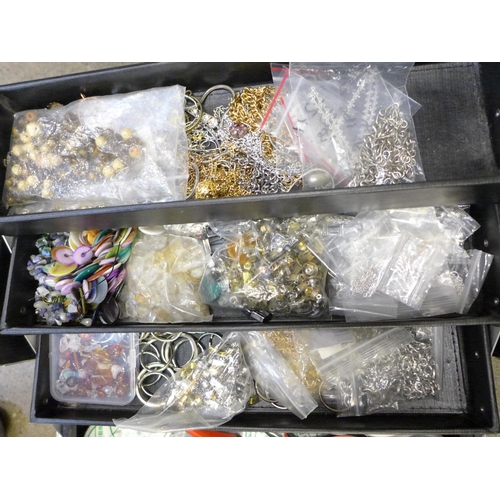 714 - A collection of jewellery making equipment including silver tone chains and fasteners, tools, semi-p... 