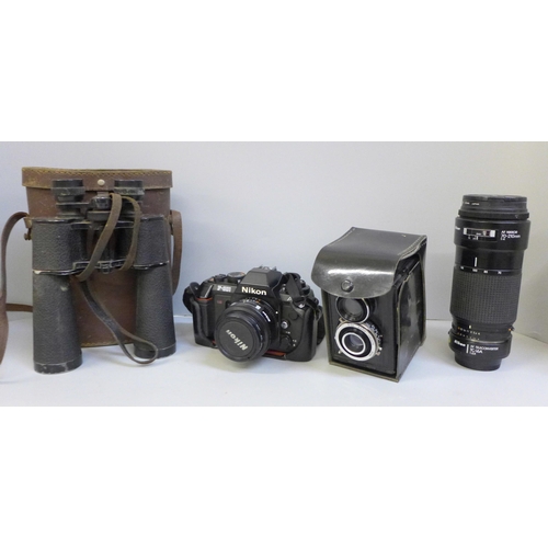 723 - A Nikon F-501 camera, a Nikon 70-210mm lens, a pair of Lieberman & Gortz 20 x 40 binoculars and a Lu... 