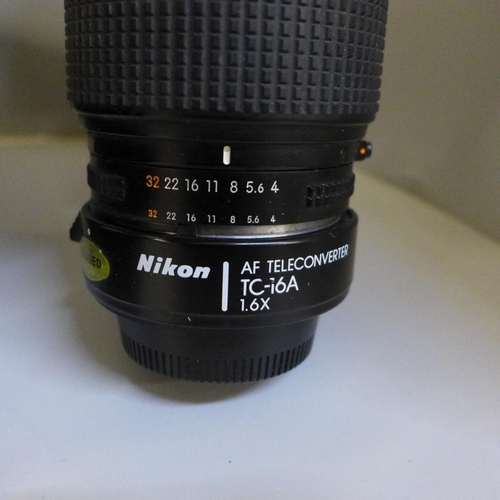 723 - A Nikon F-501 camera, a Nikon 70-210mm lens, a pair of Lieberman & Gortz 20 x 40 binoculars and a Lu... 