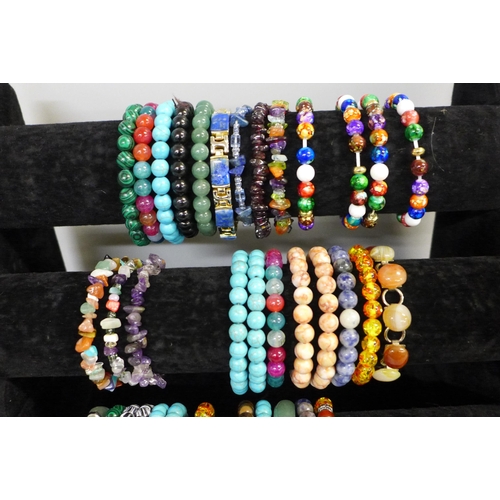 738 - 37 Semi precious stone bracelets on a display stand