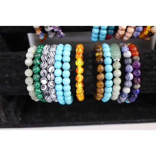 738 - 37 Semi precious stone bracelets on a display stand