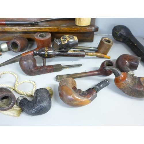 758 - A collection of twenty-three pipes and two pipe racks