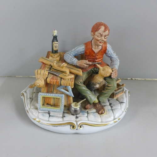 768 - A signed Capodimonte porcelain figure of Geppetto and Pinocchio