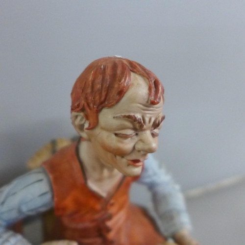 768 - A signed Capodimonte porcelain figure of Geppetto and Pinocchio