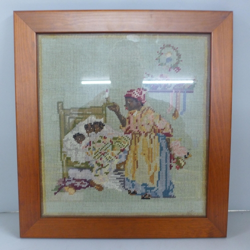 773 - A maple framed woolwork picture of a nanny and three children, 38cm x 41cm