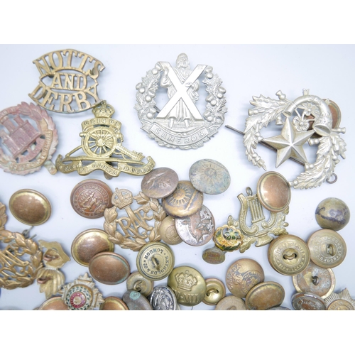 805 - A collection of military uniform buttons and other buttons and military cap badges including Cameron... 