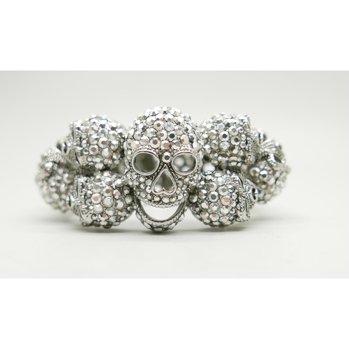 836 - A Butler & Wilson large skull bracelet, some stones missing, 6cm x 5cm